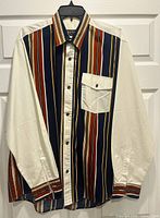 Front view of multicolour striped cotton shirt with white sleeves and chest pocket on hanger