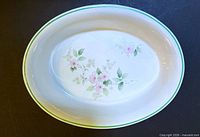 Top view showing floral interior design and green rim of oval dish