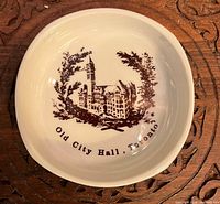 Front view showing brown Old City Hall Toronto illustration and text on white plate
