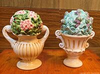 Front view of both urn-shaped floral topiary shakers