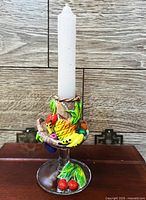 Full view of candlestick holder with candle inserted