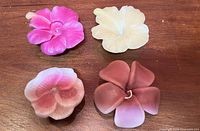 top view of four flower candles showing colors and petal detail