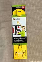 Front view of packaged Hang & Level tool