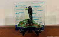 Front view of dish on stand showing lighthouse design
