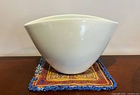Front profile showing curved saddle-wave rim of white ceramic bowl