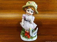 Front view of Lefton porcelain girl figurine with duck
