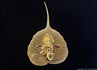 Front view of gold plated peepal leaf with Ganesha