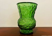 Full side view of emerald green textured glass vase