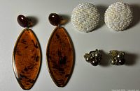 All three pairs of clip-on earrings laid out