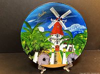 Full view of painted terracotta plate on stand