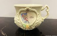 Front of cup showing illustration and Faith text