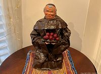 Front three-quarter view of monk sculpture on table