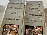 All eight instructional booklets laid out showing titles