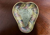 Top view showing pear shape and enamel leaf motif