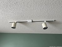 Full view of installed white 2-light track on ceiling