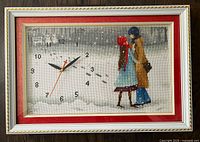 Front view of framed cross-stitch wall clock upright