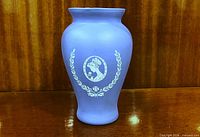 Front view showing Victorian cameo decoration and vase shape