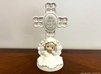 Front view showing full figurine with cross and plaque