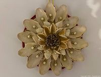 Front view showing seashell petals and pearl accents