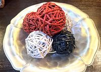 Top view showing all five rattan balls in red, white and black