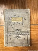 Front cover showing decorative design and gilt title panel