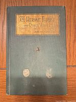 Front cover showing title, author, cloth binding, stains