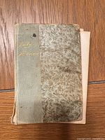 Front cover showing marbled board, green cloth spine with gilt "Daily Manna"