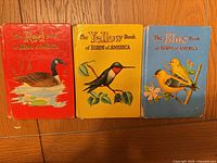Front covers of three color-coded bird books