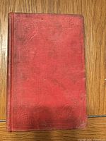 Front cover showing red cloth and blind stamping