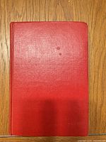Front cover showing red cloth binding without dust jacket