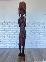 Full front view of entire 64-inch wooden figure