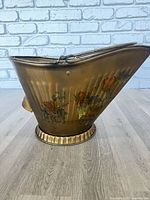 Side view of gold-tone hand painted pail
