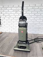 Front view of Hoover green upright vacuum cleaner