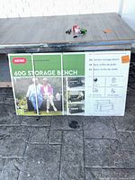 Front of sealed Keter 60G Storage Bench box showing product image and branding