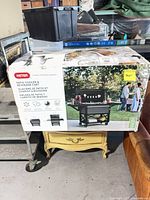 Factory-sealed box showing Keter patio cooler cart image and product details