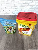 Preen bucket and Impact Organics bag side by side