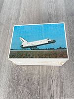 Top view showing first postcard with Space Shuttle landing image