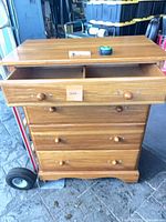Front view of oak dresser showing four drawers and knobs