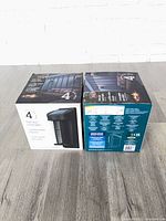 Two sealed boxes of solar post accent lights, front and back views