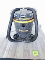 Front view of Vacmaster 12-gallon vacuum with hose attached