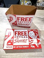 Front and side view of one Squirt holder showing graphics and empty interior