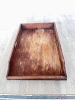 Top view of wooden serving tray showing interior surface and side handles