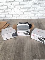 Three boxed VR Play headsets on floor