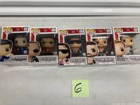 Six WWE Funko Pop! figures in boxes