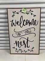 Front view of wood framed wall sign showing design and condition