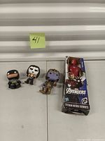 Overall view showing three loose Funko Pop vinyl figures and one boxed Marvel Avengers Titan Hero Series figure