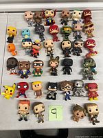 Full group shot of 35 loose Funko Pop figures arranged on table