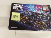 Sealed retail box showing Numark Party Mix controller and built-in party lights feature