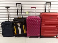 Group shot of four suitcases lined up