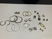 Overview of all 14 earring pairs on white background